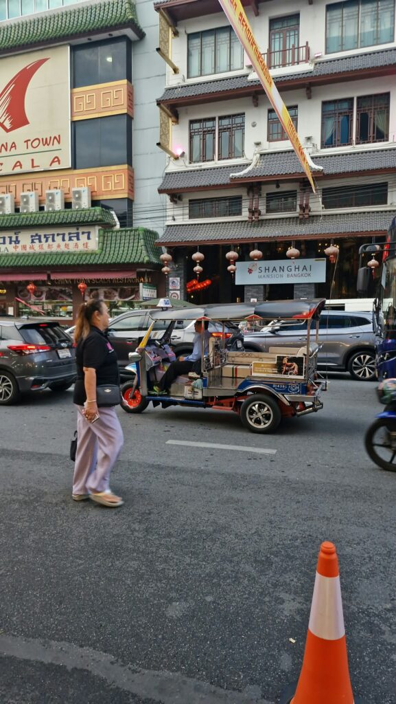 Tuk-tuk in front of the shops of Yaowarat