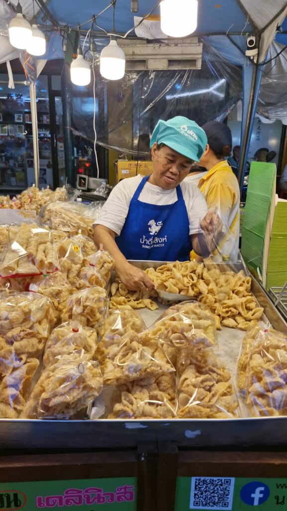 Vendor serving fried vegetarian snacks