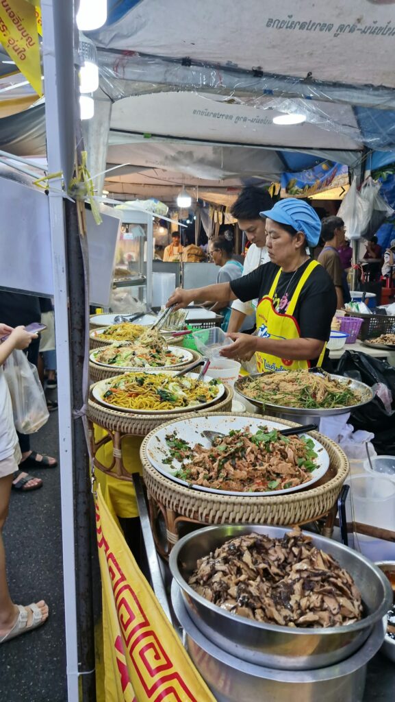 Dishes of stir-fried vegetables on a festival stall