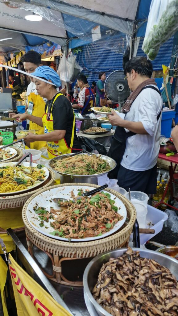 Plates of noodles and vegetarian dishes ready to take away