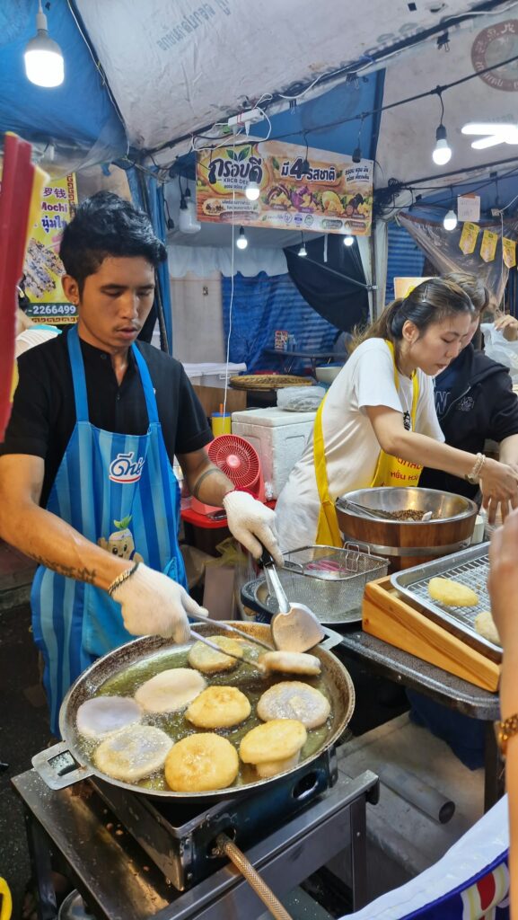Cook preparing vegetarian dishes in a wok