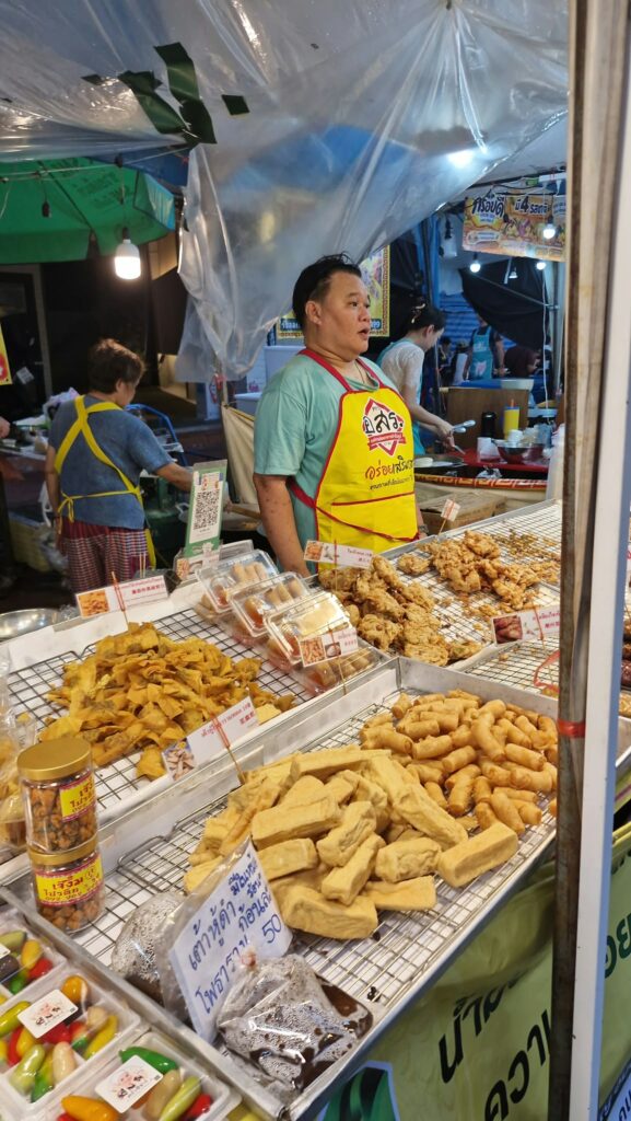 Stall selling vegetarian fritters and fried rolls