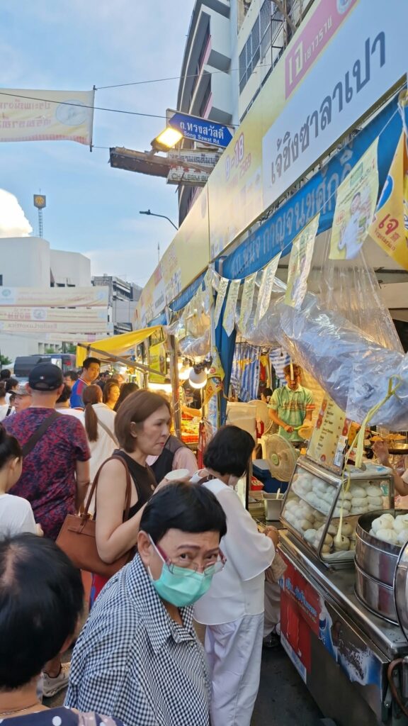 Visitors among the colourful stalls of the vegetarian festival